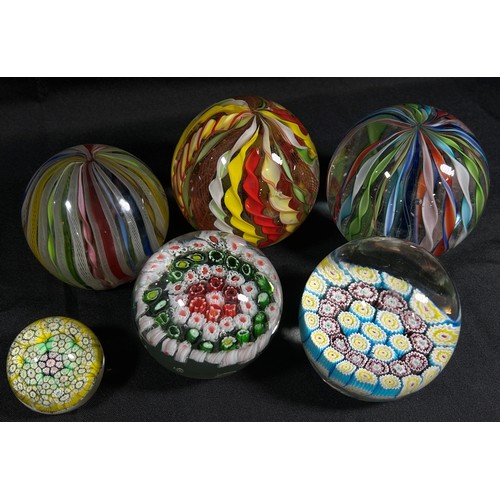 188 - Two millefiori cane glass paperweights, a third much smaller,  and three Murano Twisted Ribbon paper... 