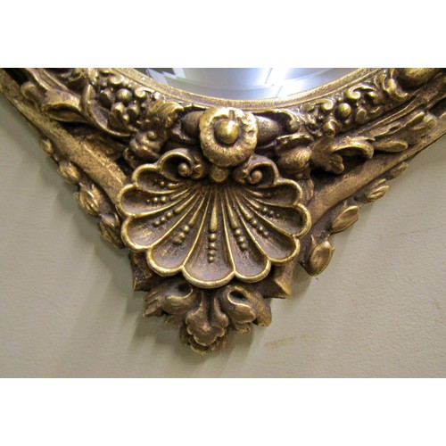 1360 - An early 19th century style gilt wall mirror supporting two candle sconces within a decorative frame... 