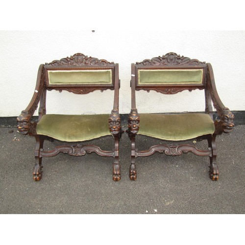 1556 - A pair of 19th century continental walnut X framed side chairs with heavily carved detail