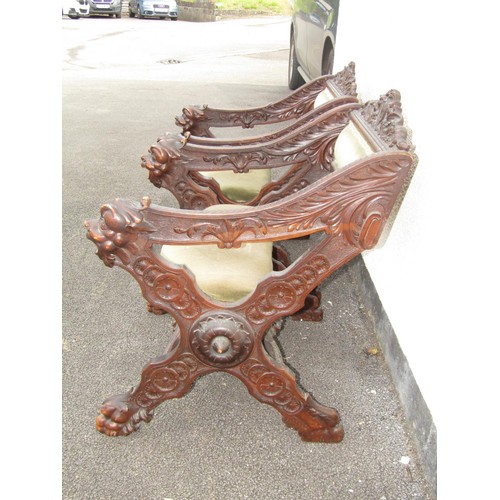 1556 - A pair of 19th century continental walnut X framed side chairs with heavily carved detail