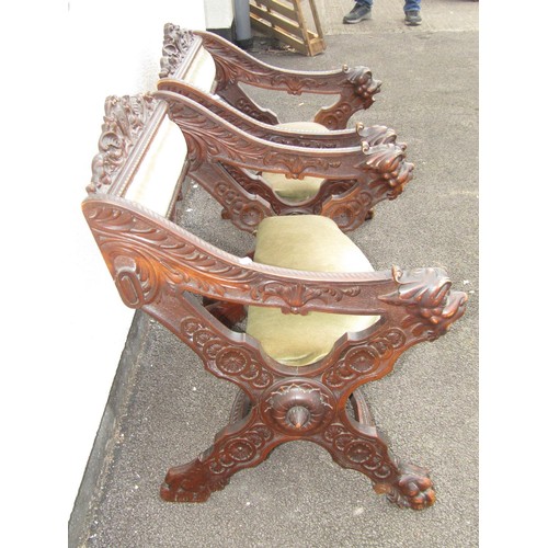 1556 - A pair of 19th century continental walnut X framed side chairs with heavily carved detail