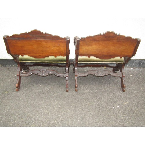 1556 - A pair of 19th century continental walnut X framed side chairs with heavily carved detail