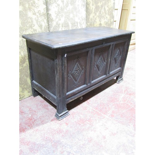 1557 - An antique oak coffer, the three panelled front with geometric carved detail, 76cm high x 138cm wide... 