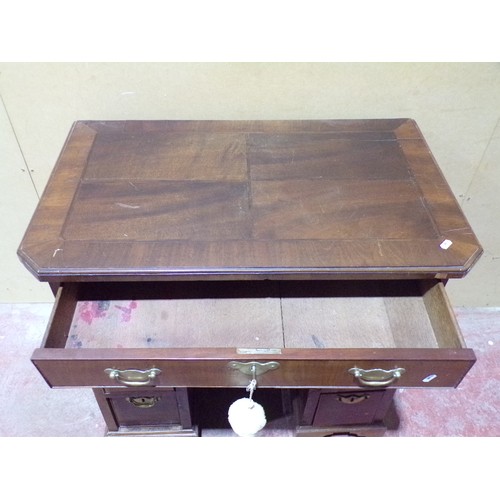 1559 - A Georgian style mahogany and oak lined kneehole desk or eight drawers and central cupboard, 77cm hi... 