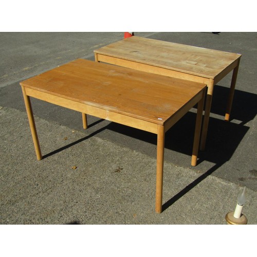 1575 - A pair of vintage Ercol tables, the elm tops raised on circular supports, 1222cm long x 69cm wide, t... 