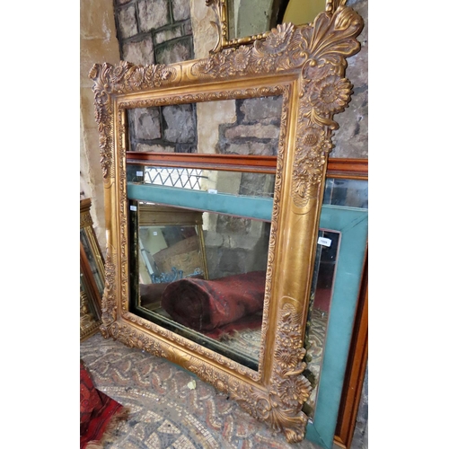 1316 - A large contemporary gilt mirror or picture frame, with foliate detail, 142cm x 116cm approx