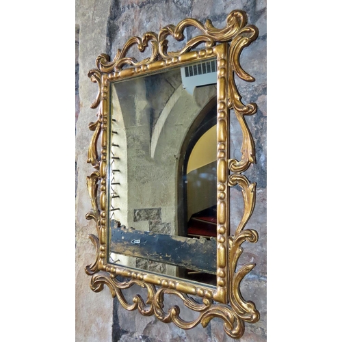 1317 - A gilt framed wall mirror, with open scrolling acanthus surround, 74cm x 48cm