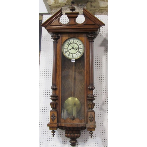 336 - A 19th century Vienna regulator wall clock in a walnut case of architectural form, with twin weight ... 