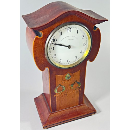 344 - An Edwardian mahogany mantle clock in the Art Nouveau style, the enamelled dial with black Arabic nu... 