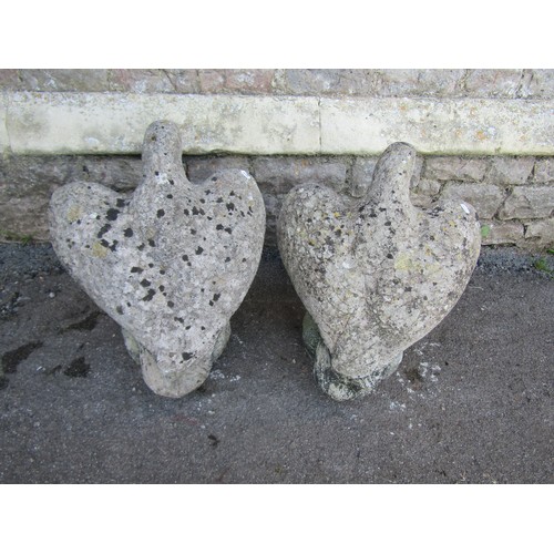 1049 - Pair of weathered cast composition stone eagles, 50cm high