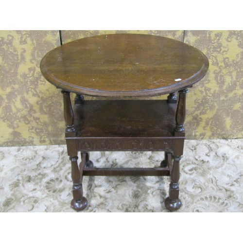 1211 - A reproduction oak monks seat with circular top and carved detail, together with an Old English styl... 