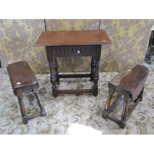 1211 - A reproduction oak monks seat with circular top and carved detail, together with an Old English styl... 