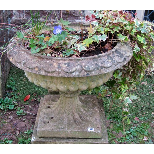 1035 - Weathered cast composition stone garden urn, the squat circular lobed bowl with flared rim and loose... 