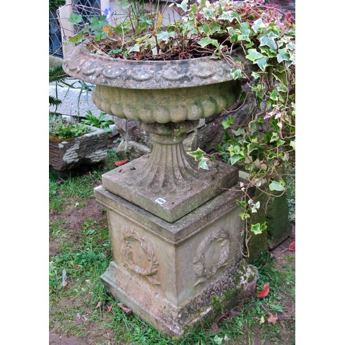 1035 - Weathered cast composition stone garden urn, the squat circular lobed bowl with flared rim and loose... 