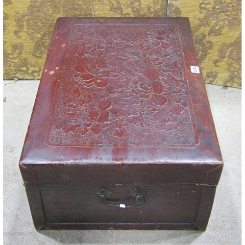 1202 - A Chinese leather overlaid trunk with embossed floral detail, 26cm high x 66cm x 44cm