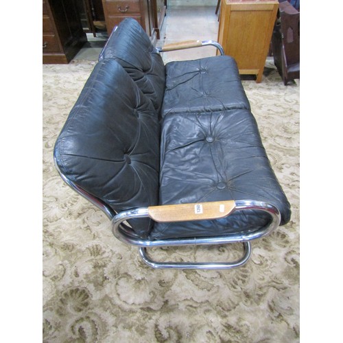 1260 - A retro style low tubular framed two seat sofa with loose buttoned cushions, 70cm high x 140cm long ... 