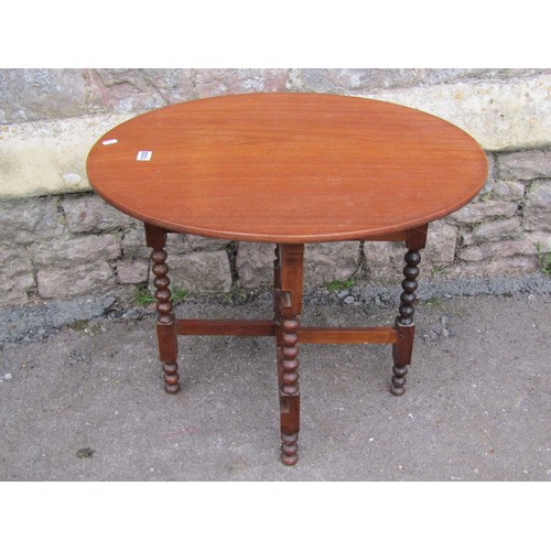 1332 - Mahogany folding coaching type table on turned bobbin supports, with applied paper registration vers... 