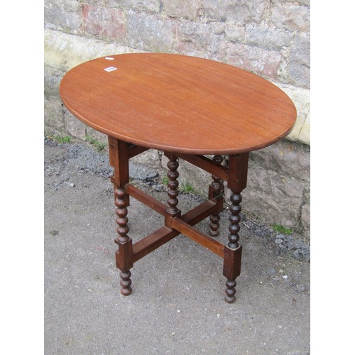 1332 - Mahogany folding coaching type table on turned bobbin supports, with applied paper registration vers... 