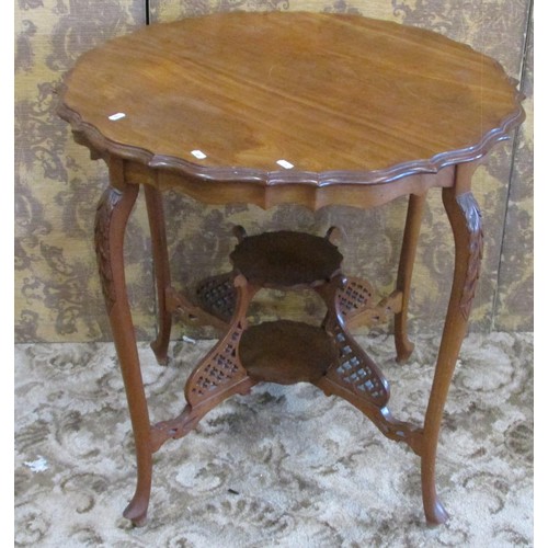 1333 - An Edwardian mahogany occasional table the circular top with serpentine moulded outline raised on sl... 