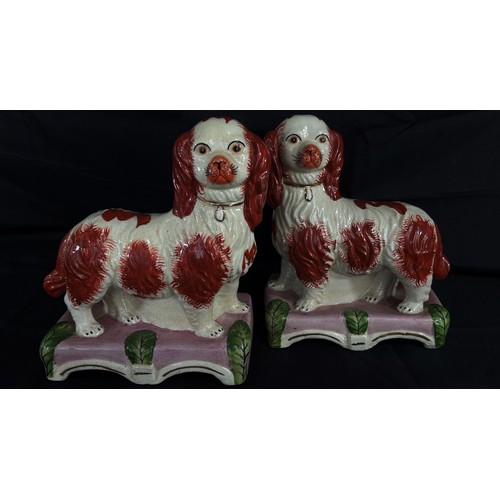 111 - A decorative pair of Staffordshire models of standing spaniels, each 25cm high, 20cm wide.