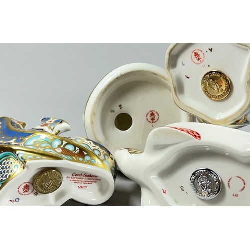 62 - A collection of Royal Crown Derby Imari figures comprising a Dolphin and a Seahorse with gold stoppe... 