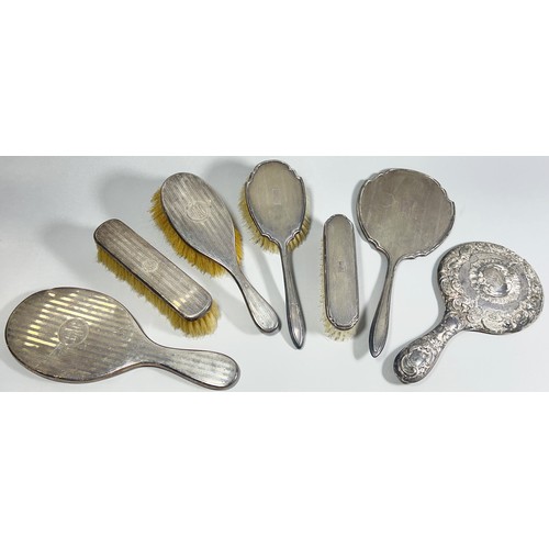 302 - A silver hairbrush, clothes brush and mirror set of three, initialled BAC, together with two further... 