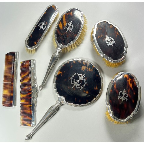 308 - A silver and tortoiseshell dressing table set of 4 brushes, two combs and a hand mirror, Birmingham,... 