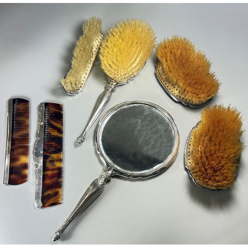 308 - A silver and tortoiseshell dressing table set of 4 brushes, two combs and a hand mirror, Birmingham,... 