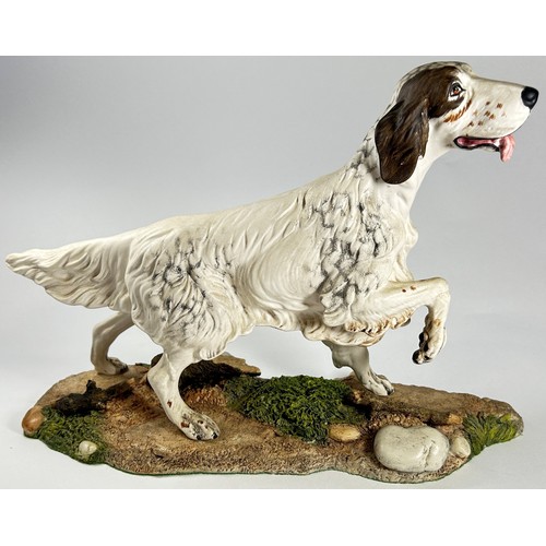 24 - Five ceramic models of dogs in various poses including a Beswick white matt example of a Spaniel, a ... 