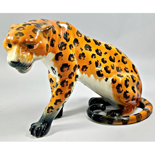 64 - A ceramic model of a Royal Doulton Leopard 'The Watering Hole' set on a wooden plinth, together with... 