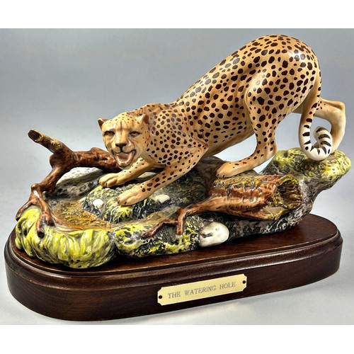 64 - A ceramic model of a Royal Doulton Leopard 'The Watering Hole' set on a wooden plinth, together with... 