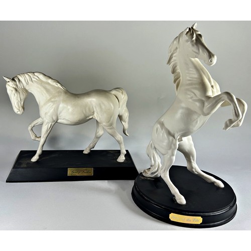 31 - Four matt glazed ceramic figures by Royal Doulton of horses in various poses, two in black and two i... 