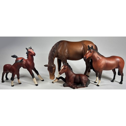 32 - A collection of seven Beswick ceramic horses and foals in various poses in a matt glaze finish, toge... 