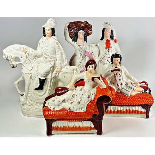 37 - A collection of Staffordshire figures to include two reclining figures, equestrian and other figures... 