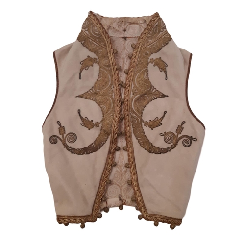 824 - A 19th century child's waistcoat heavily embroidered with couched goldwork on woollen ground, partia... 