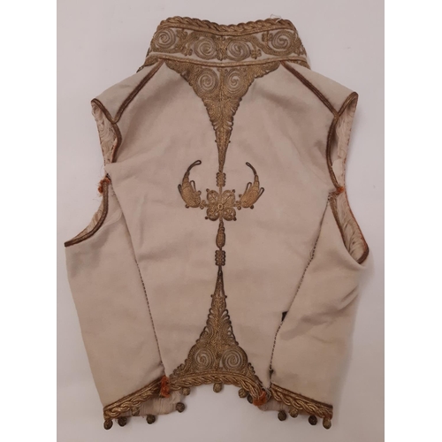 824 - A 19th century child's waistcoat heavily embroidered with couched goldwork on woollen ground, partia... 