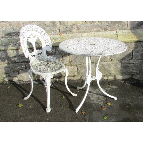 1013 - A cream painted  and weathered cast aluminium garden terrace table with decorative circular pierced ... 