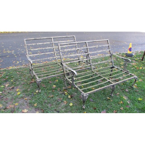 1015 - A pair of painted steel two seat garden sofas with open strapwork seats and backs, scrolled arms and... 