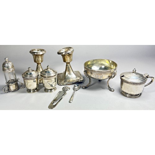 310 - A mixed selection of silver, including condiments, two squat candlesticks, a page marker and a condi... 