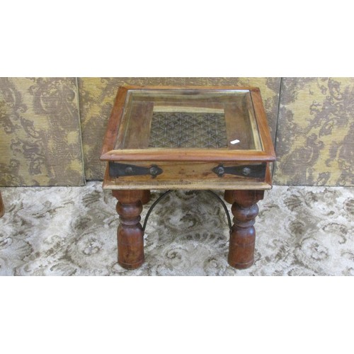 1288 - A low Indian hardwood occasional table with decorative iron work lattice panelled top with glass cov... 