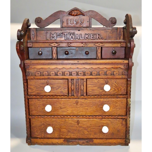 622 - A 19th century oak apprentice chest of drawers, dated 1899 to a Mrs T Walker, with a row three friez... 