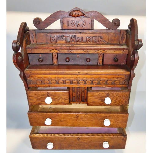 622 - A 19th century oak apprentice chest of drawers, dated 1899 to a Mrs T Walker, with a row three friez... 