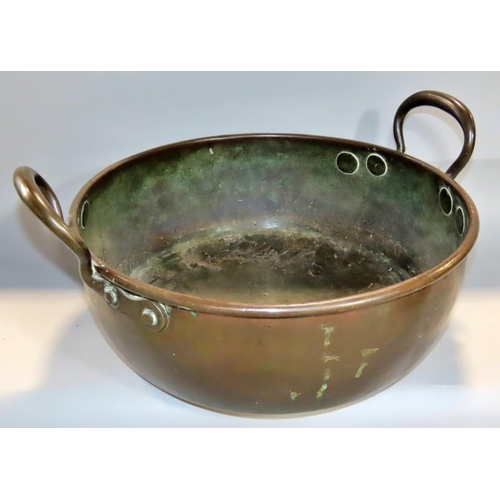 646 - A 19th century patinated copper circular pan with loop handles, 38cm diameter