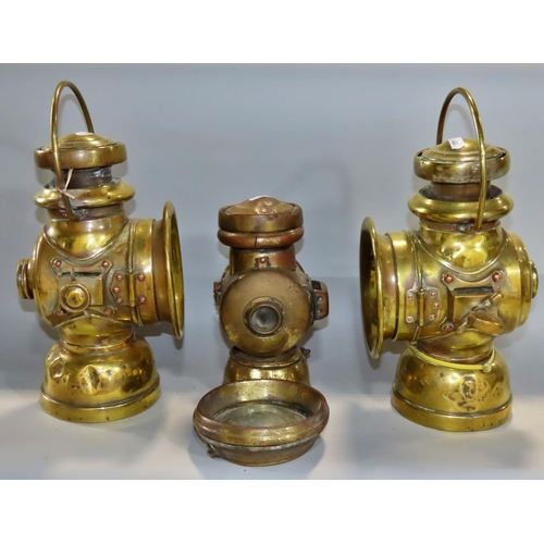 647 - Two vintage brass Belsize 104 paraffin car lamps together with a smaller brass car lamp (af)