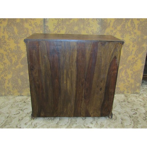 1338 - A small Indian hardwood dresser enclosed by a pair of arched lattice panelled doors beneath two frie... 