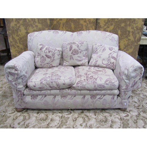 1335 - An Edwardian two seat sofa with shaped outline, upholstered finish and single drop arm, 156cm long