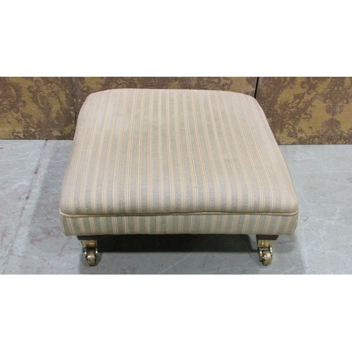 1336 - A contemporary low foot stool with striped upholstered seat raised on polished canters, 28 cm high x... 