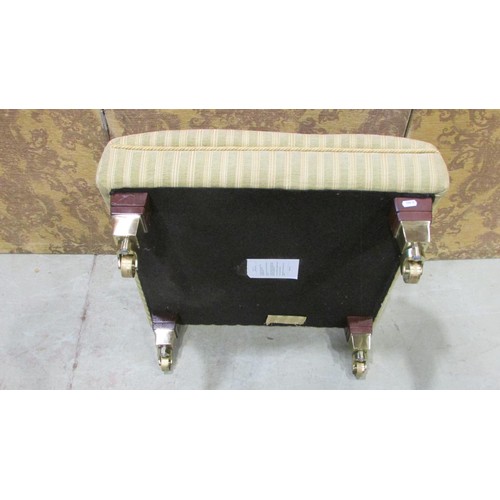 1336 - A contemporary low foot stool with striped upholstered seat raised on polished canters, 28 cm high x... 