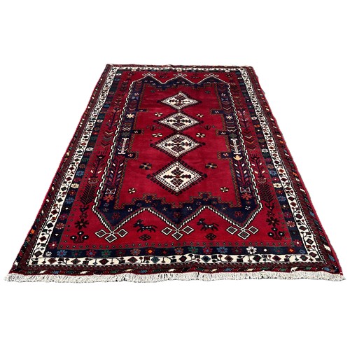 1733 - A North West Persian Cirjan carpet, with geometric medallions on a predominantly red ground,292cm x ... 