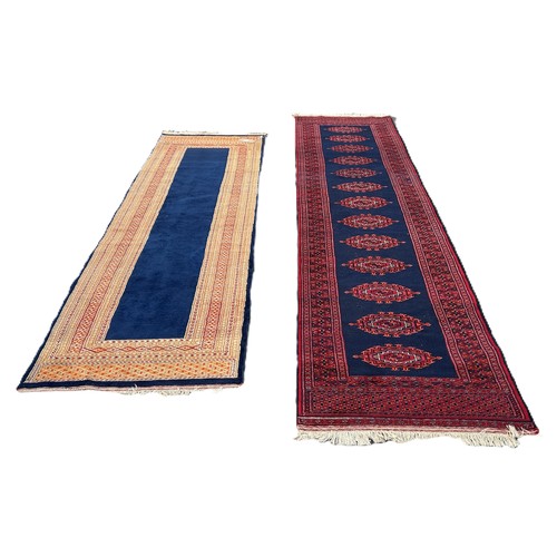 1750 - A Kashmiri runner with a central row of connected medallions on a dark blue ground 325cm x 80cm appr... 